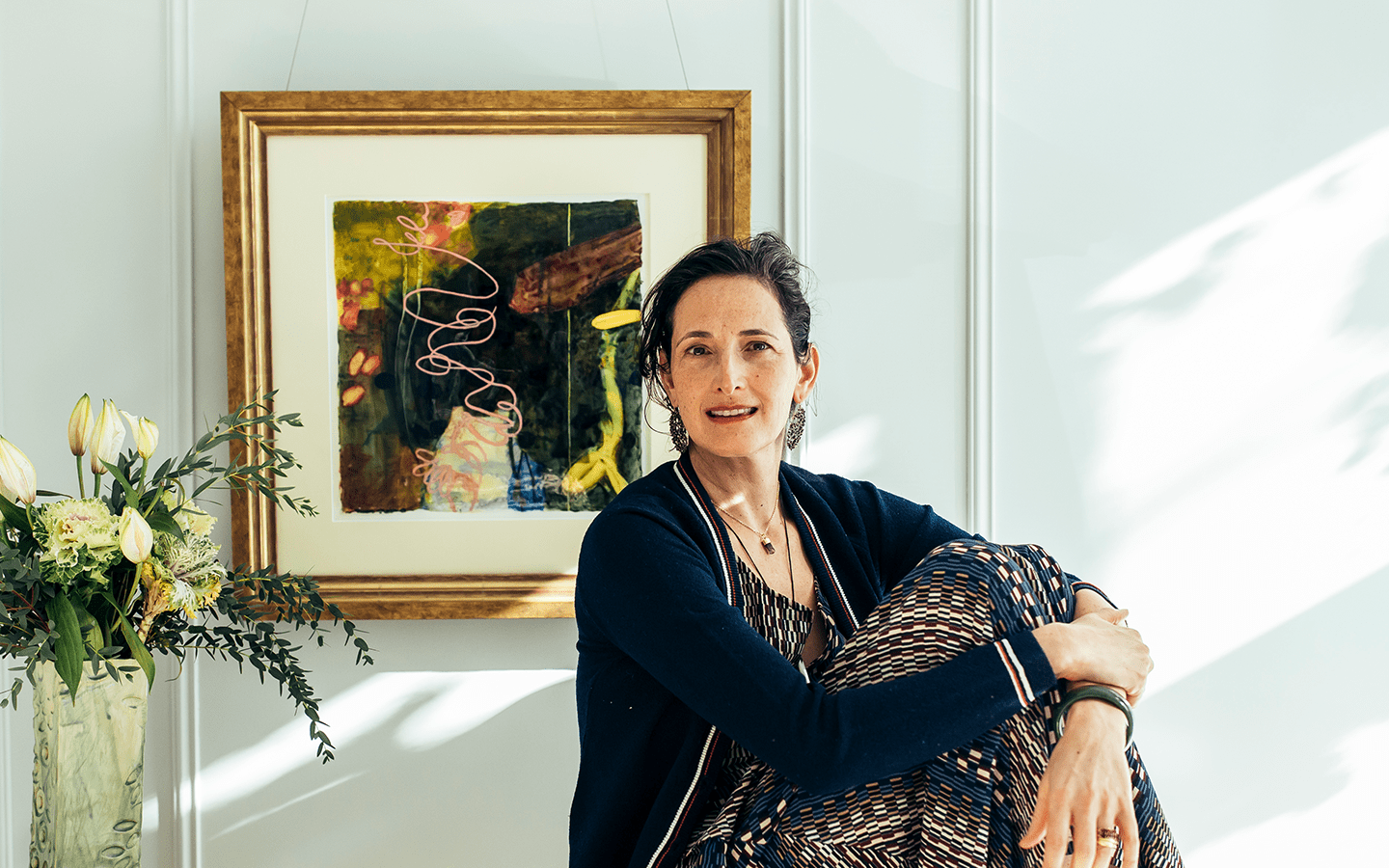 Dr. Catherine Price smiling warmly in her sunlit home, embodying ease and vitality