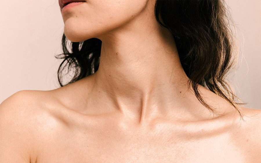Close-up of a woman's neck and shoulders with dark hair