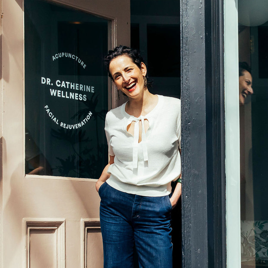 Dr. Catherine Price laughing in the doorway of her Newport, Rhode Island studio